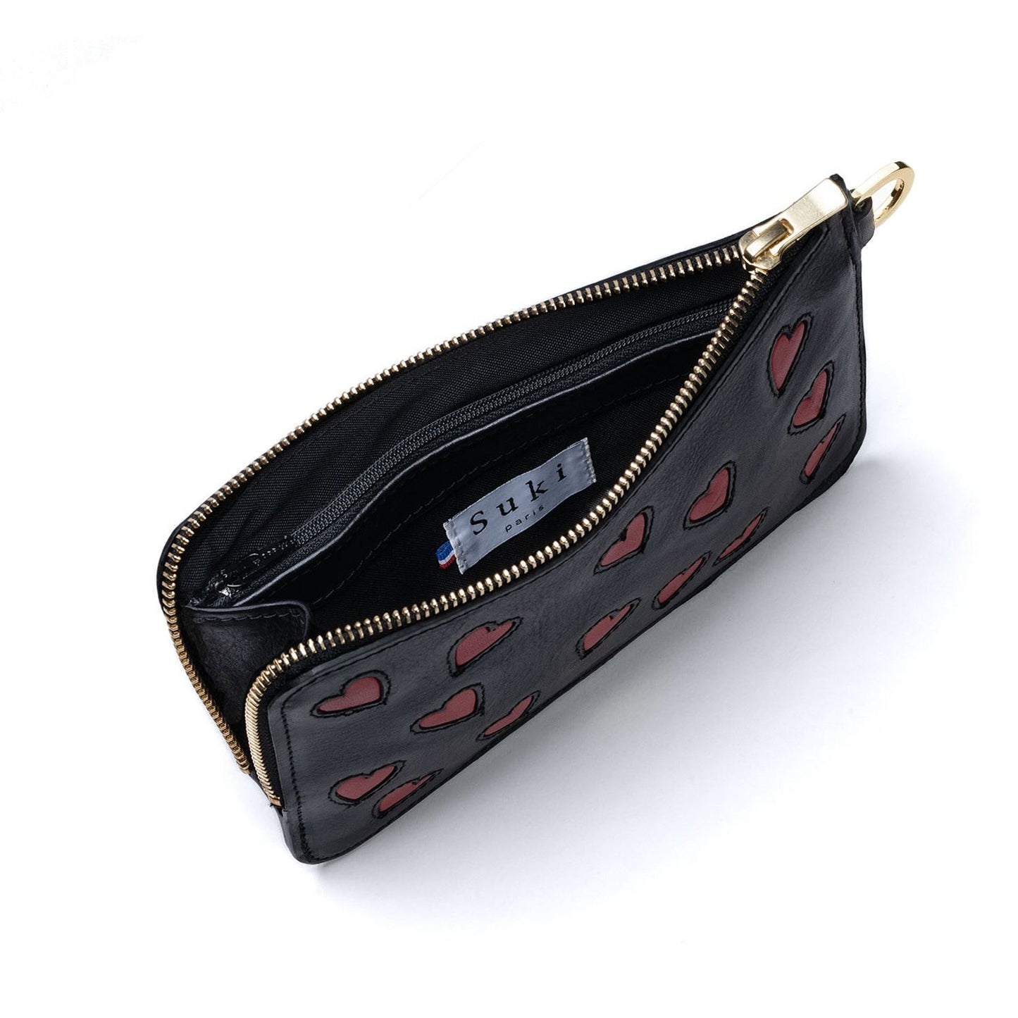 Atelier de maroquinerie à Paris. Pochette créateur au design unique made in France. Maroquinerie française fabriquée en petite série. Pochette personnalisable.